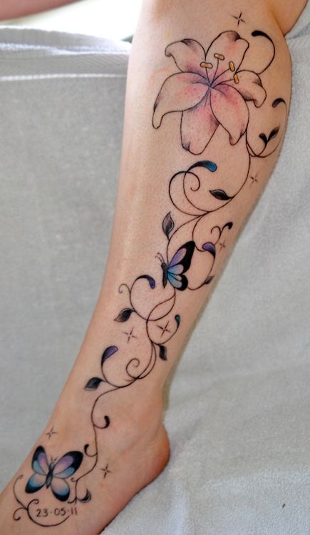 a woman's foot with a flower and butterfly tattoo design on the left side of her leg