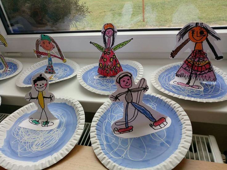 paper plates with children's drawings on them are sitting in front of a window