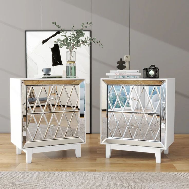 two mirrored nightstands sitting on top of a wooden floor