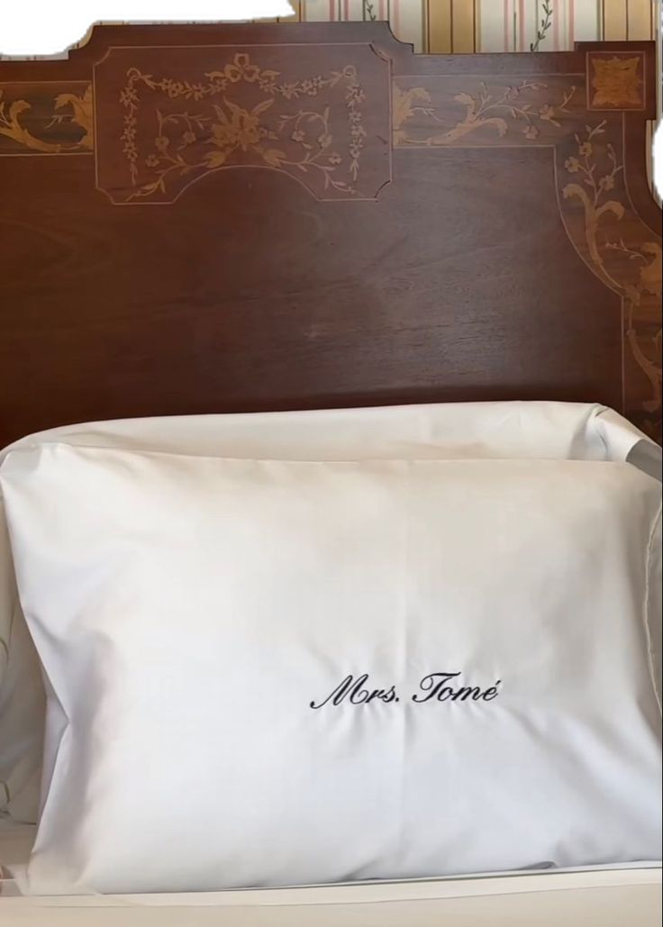 a pillow that is on top of a bed with the name miss jones written on it