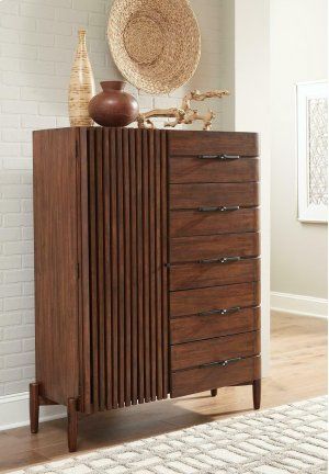 a wooden dresser sitting in front of a white wall with a basket on top of it