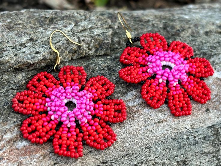 Add a touch of vibrant elegance to your look with these handmade beaded flower earrings. Each pair features a unique blend of colors, from deep blues to warm oranges and pinks, inspired by the beauty of nature. Perfect for any occasion, these earrings are lightweight and versatile, making them an ideal accessory for both casual and formal outfits. Whether you're looking to brighten up your wardrobe or searching for a thoughtful gift, these floral earrings are sure to make a statement.🌼🌸 Featur Pink Beaded Drop Flower Earrings, Pink Flower Beaded Earrings For Gift, Multicolor Handmade Flower Earrings, Handmade Pink Beaded Flower Earrings, Handmade Pink Flower Earrings With Round Beads, Handmade Flower-shaped Beaded Earrings As A Gift, Handmade Flower Beaded Earrings As Gift, Handmade Flower Shaped Beaded Earrings As Gift, Coral Beaded Earrings For Gifts