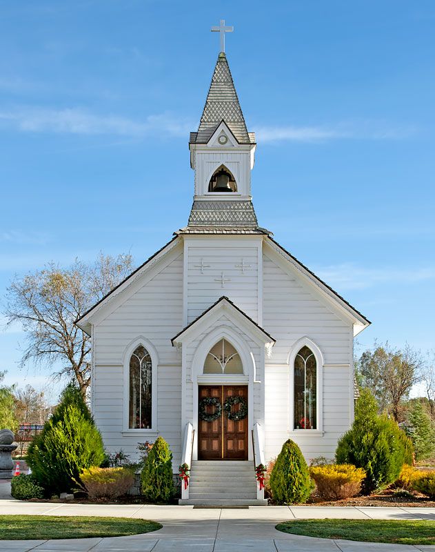 a white church with a steeple and door