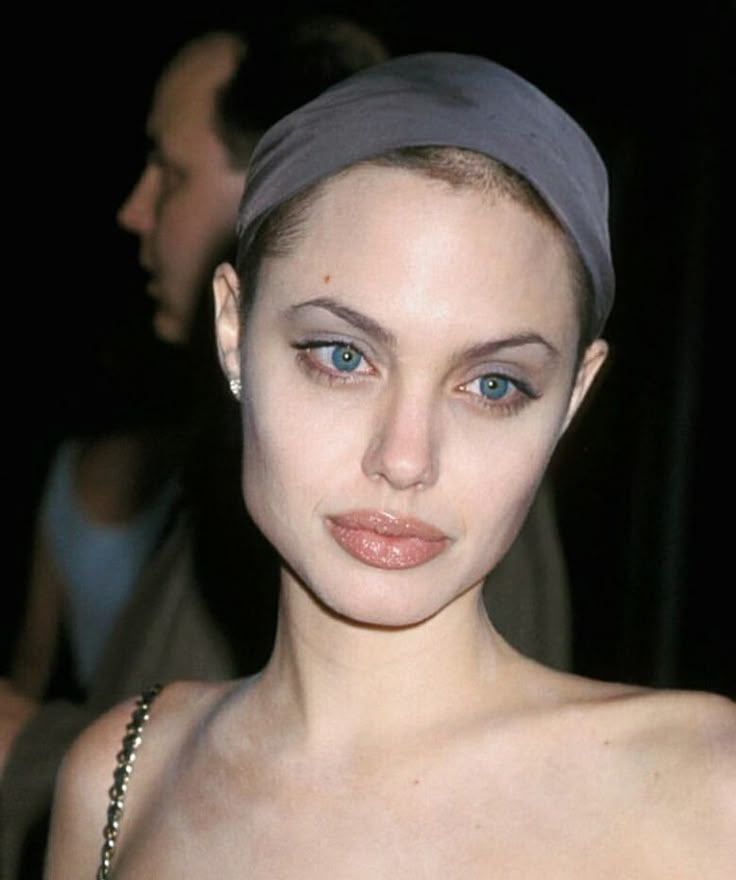 a woman with blue eyes wearing a headband