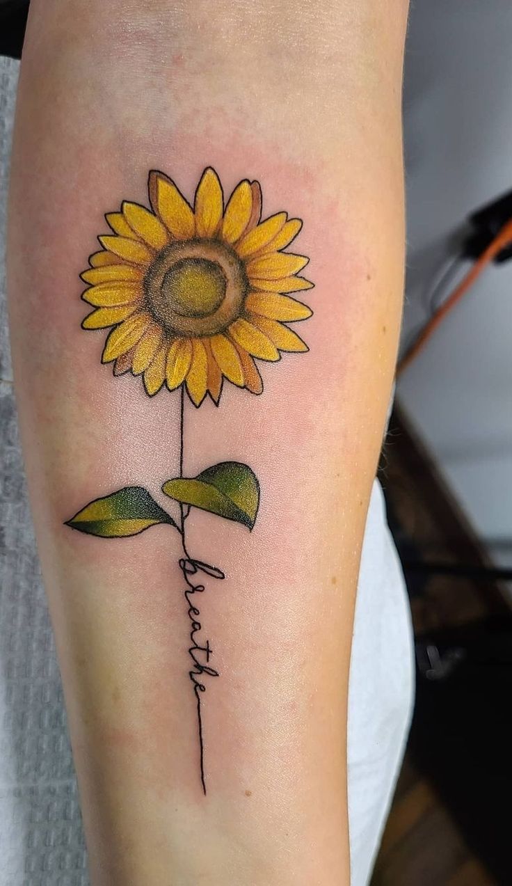 a sunflower with the word faith tattooed on it's side calf tattoo design