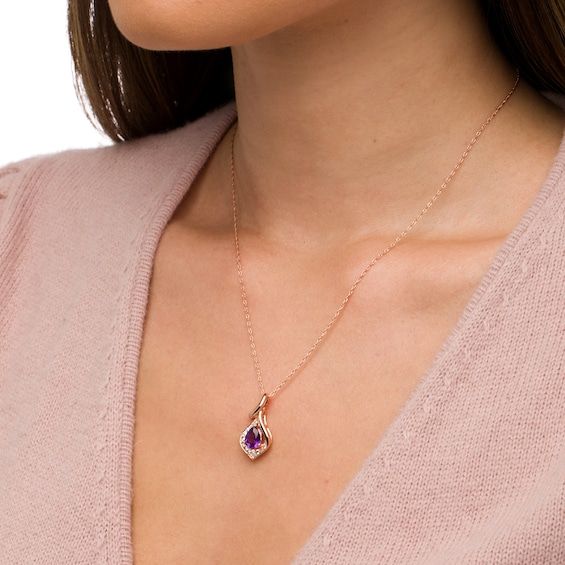 Incorporate your vibrant birthstone into your everyday look with this tasteful pear-shaped amethyst and white lab-created sapphire teardrop pendant. Crafted in sterling silver with 14K rose gold plate The faceted 8.0 x 6.0mm pear-shaped bright purple amethyst glistens in a teardrop-shaped frame adorned with shimmering white lab-created sapphires. The polished curvy bail completes this sophisticated style. Amethyst is the traditional birthstone for February and represents peace and tranquility. This pendant suspends along an 18.0-inch rope chain that secures with a spring-ring clasp. Elegant Teardrop Pendant Birthstone Necklace, Pear-shaped Amethyst Jewelry As Gift, Elegant Drop-shaped Birthstone Necklace, Elegant Teardrop Gemstone Birthstone Necklace, Rose Gold Birthstone Necklace With Gemstone, Rose Gold Teardrop Jewelry With Birthstone, Rose Gold Teardrop Birthstone Jewelry, Purple Teardrop Pendant Jewelry For Anniversary, Rose Gold Plate