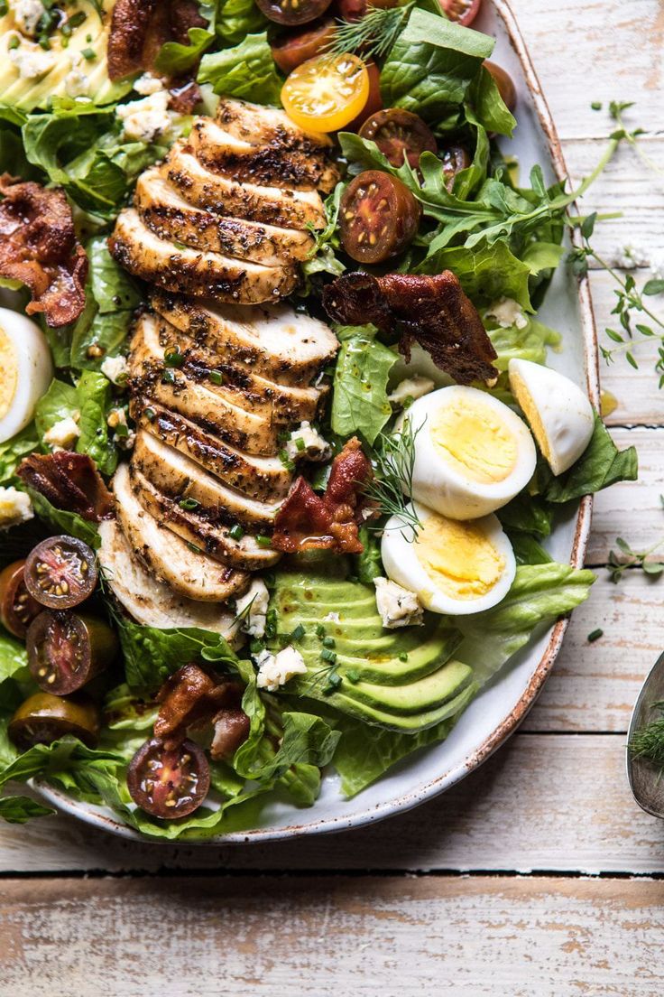 a white plate topped with salad and hard boiled eggs