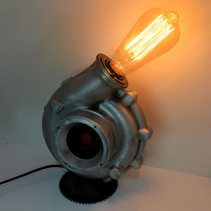 a light that is sitting on top of a metal object with a bulb attached to it