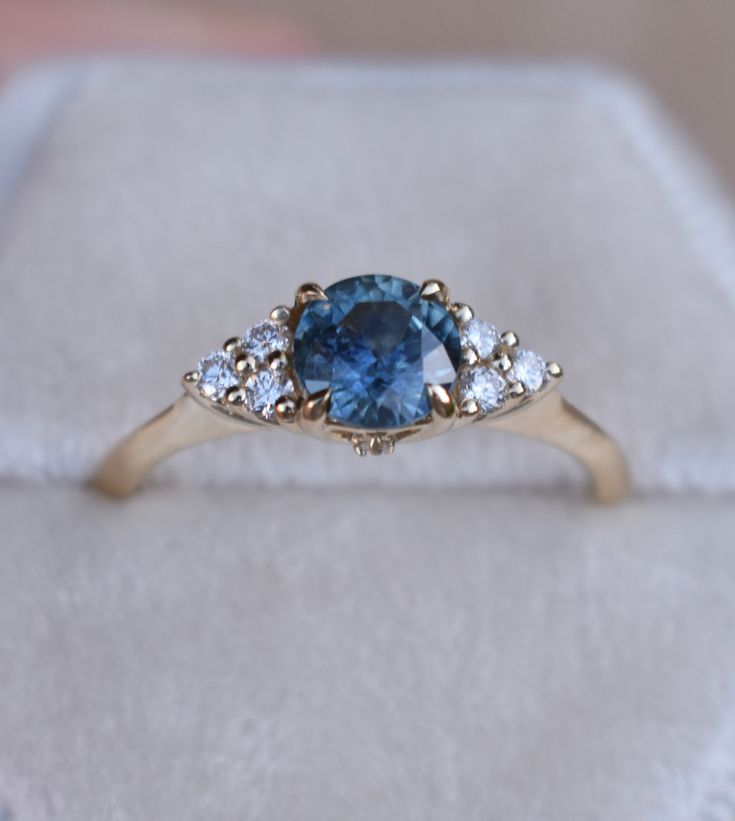 SKY BLUE MONTANA SAPPHIRE RING Once upon a time, the ancient Persians thought sapphires were so special, they believed that the earth had been created on top of the biggest blue sapphire ever, and that's why the sky was blue... It gives so romantic meaning for a blue sapphire engagement ring. One one represents a blue sapphire rig with diamonds to her or his beloved, it's considered representative of sincerity and faithfulness. This nature inspired floral design engagements ring features magic t Heirloom Blue Sapphire Diamond Ring, Timeless Blue Sapphire Ring In 14k Gold, Heirloom Blue Birthstone Rings, Timeless Blue Sapphire Birthstone Ring, Timeless Blue Sapphire Ring, 14k Gold Blue Sapphire Ring With Center Stone, Heirloom Blue Sapphire Ring With Center Stone, Timeless Blue Sapphire Ring With Accent Stones, Blue Sapphire Ring With Round Cut Gemstone