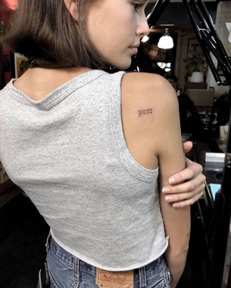 a woman with a small tattoo on her back