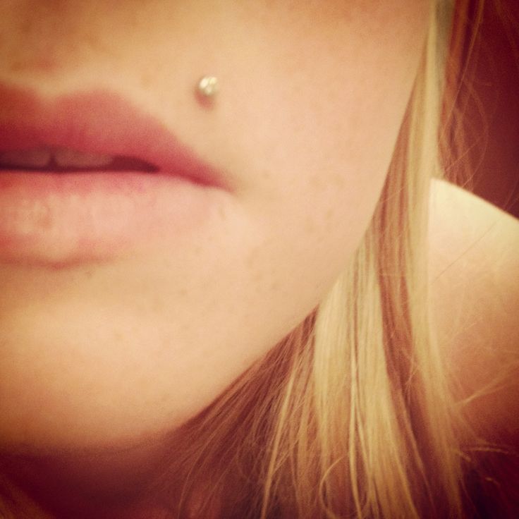 a woman's nose with a piercing on her left side and the other end of her lip