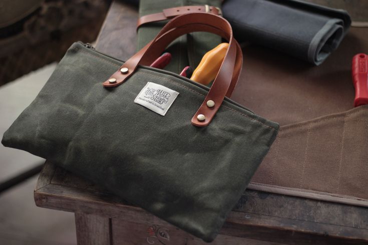 a green bag sitting on top of a wooden table