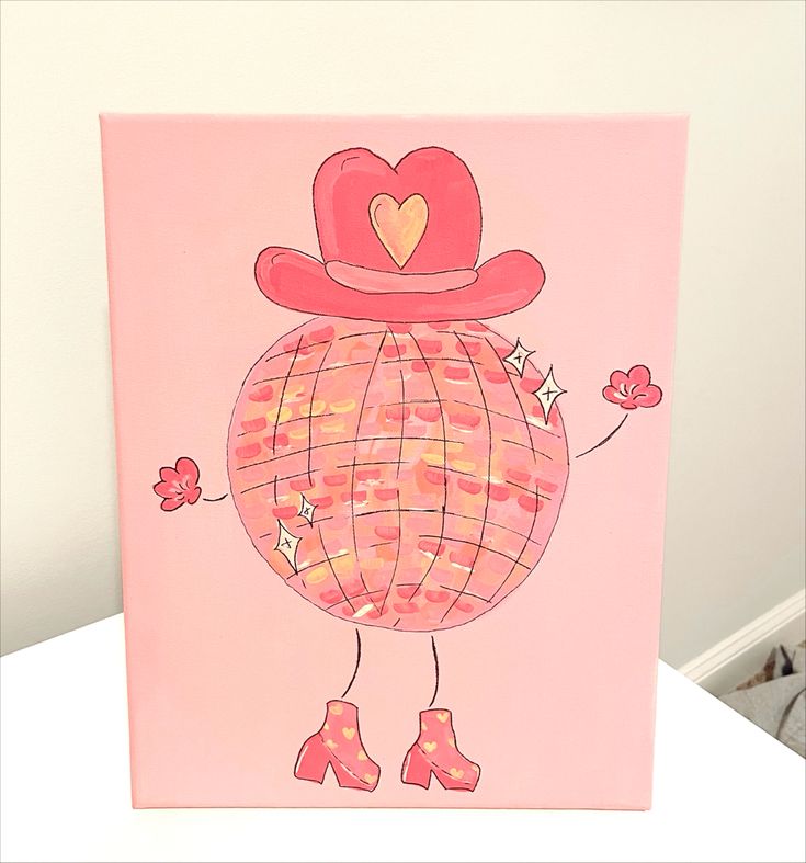 a pink greeting card with a cartoon character wearing a hat and boots on it's head