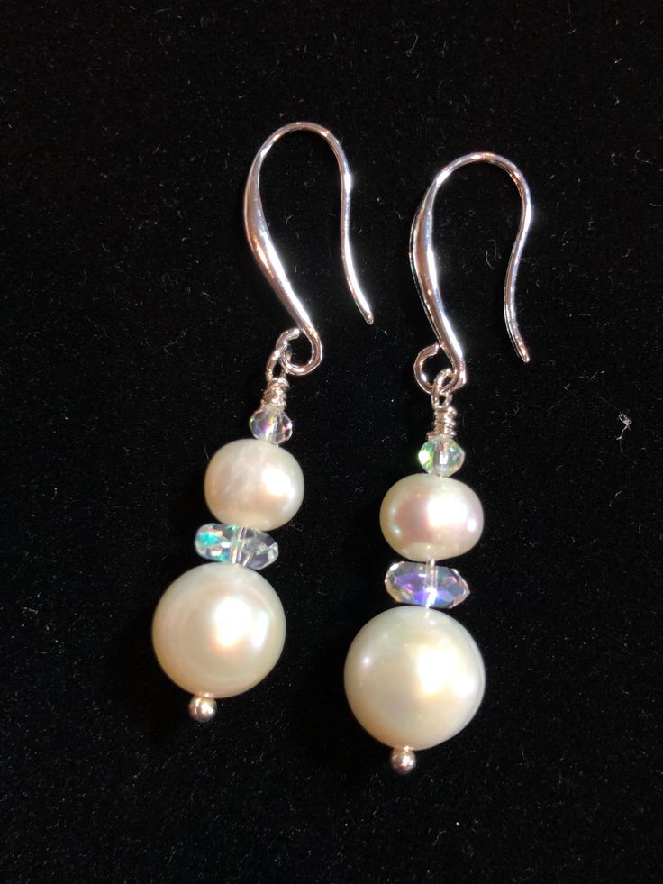 Elegant, great for wedding, Freshwater Pearls and Iridescent Crystals dangle from sterling silver ear wires.  All freshwater pearls have unique markings, shape  and color. I have beautifully matched this set for the perfect pair. They are more white than ivory and have some tinges of pink. (See photo against white) Iridescent crystals catch the light and color to add just the right amount of bling!   These have a casual elegance that can go from wedding day to your blue jean Mondays. Elegant Iridescent Drop Jewelry, Iridescent Teardrop Earrings For Wedding, Elegant Iridescent Round Jewelry, Elegant Round Iridescent Jewelry, Iridescent Pearl Drop Dangle Earrings, Iridescent Pearl Drop Earrings As Gift, Elegant Iridescent Jewelry With Pearl Charm, Iridescent Pearl Drop Earrings For Gift, Elegant Handmade Iridescent Earrings