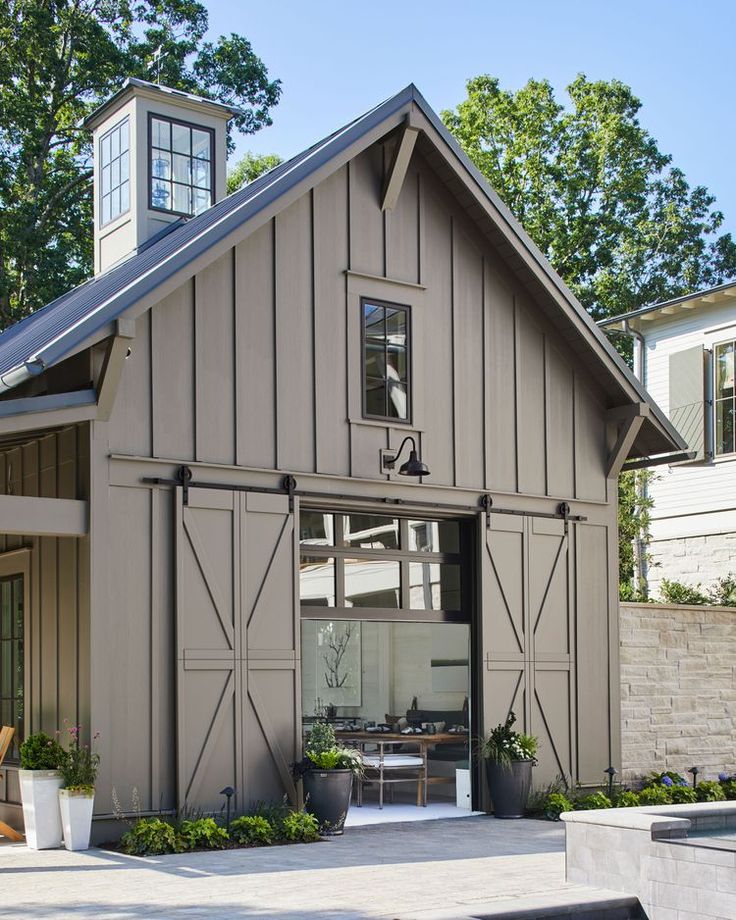 a large gray barn with an open front door