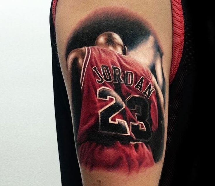 a man's arm with a basketball jersey on it and the number 22 tattooed on it