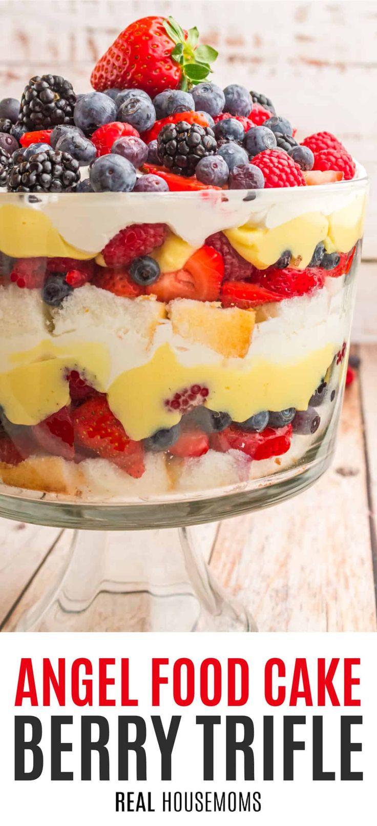 an angel food cake with berries and lemons on top is shown in the foreground