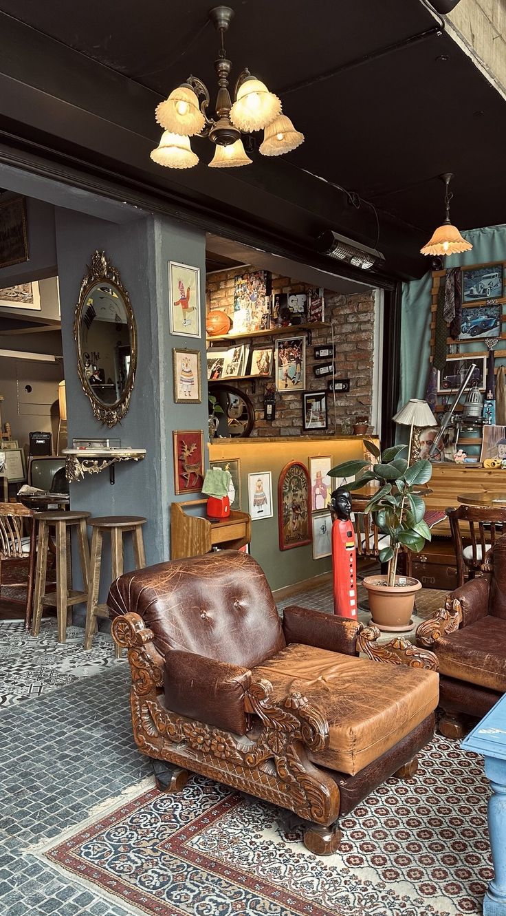 a living room filled with lots of furniture next to a wall covered in bookshelves