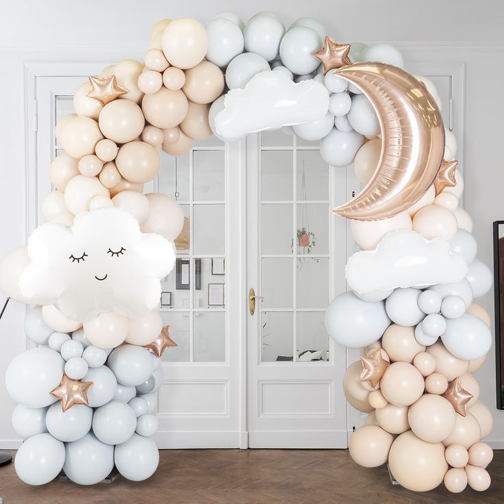 an elephant balloon arch with stars and moon balloons on the top, along with other balloons