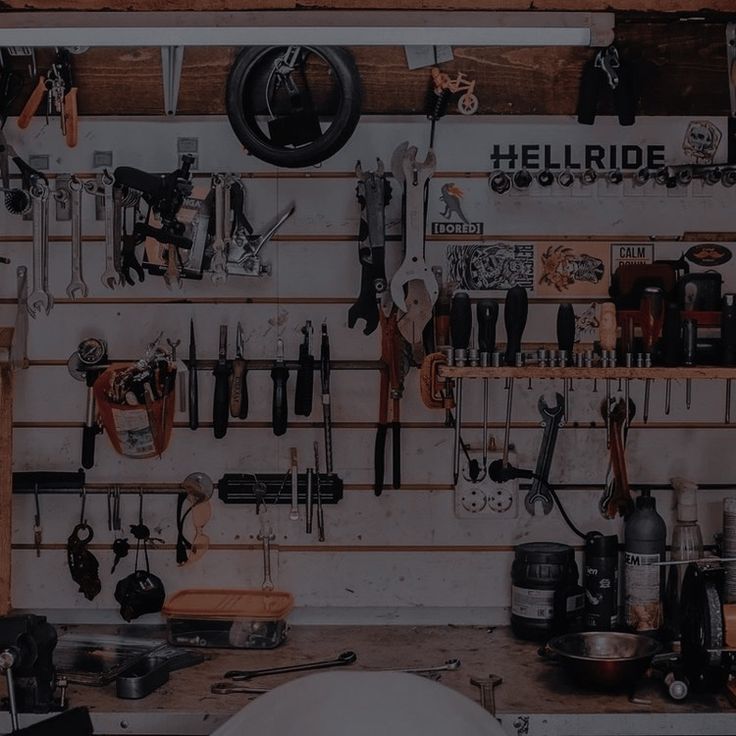 there are many tools hanging on the wall