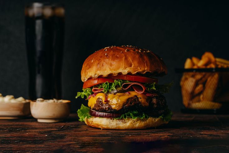 a hamburger sitting on top of a wooden table