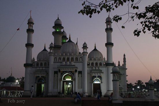 a large white building with two towers at dusk