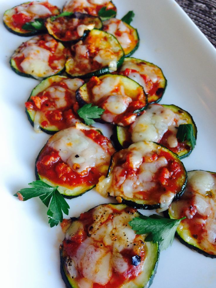 zucchini stuffed with cheese and sauce on a white plate