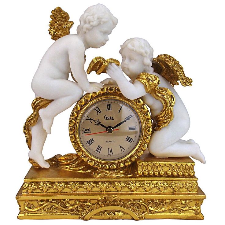 an antique clock with two cherubs on it