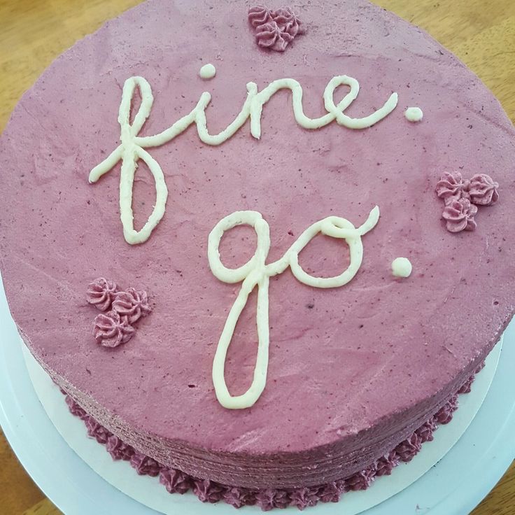 a pink cake with the word fine go written on it