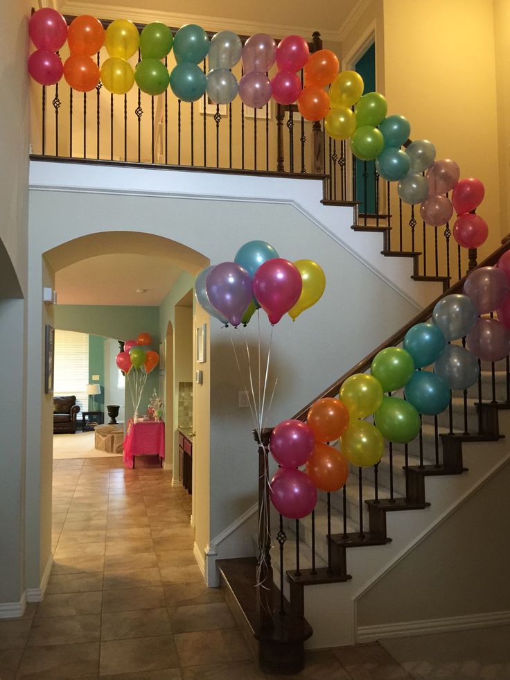 balloons are floating down the stairs in this house