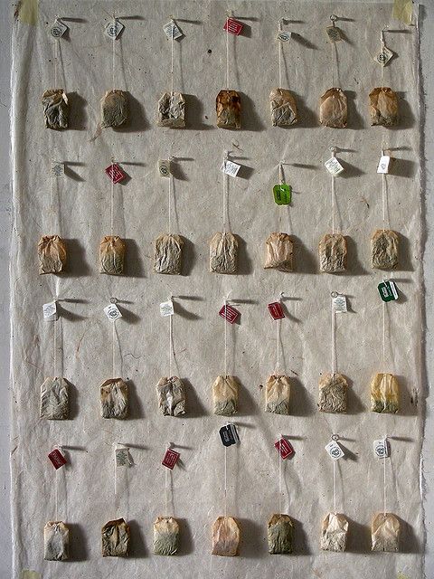 several pieces of paper are pinned to the wall with pins and magnets on them