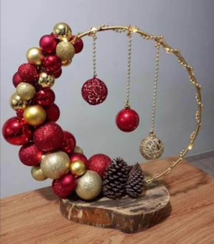 a wooden table topped with ornaments and a pine cone on top of it's side