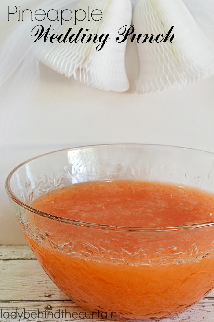 a bowl filled with orange juice on top of a wooden table