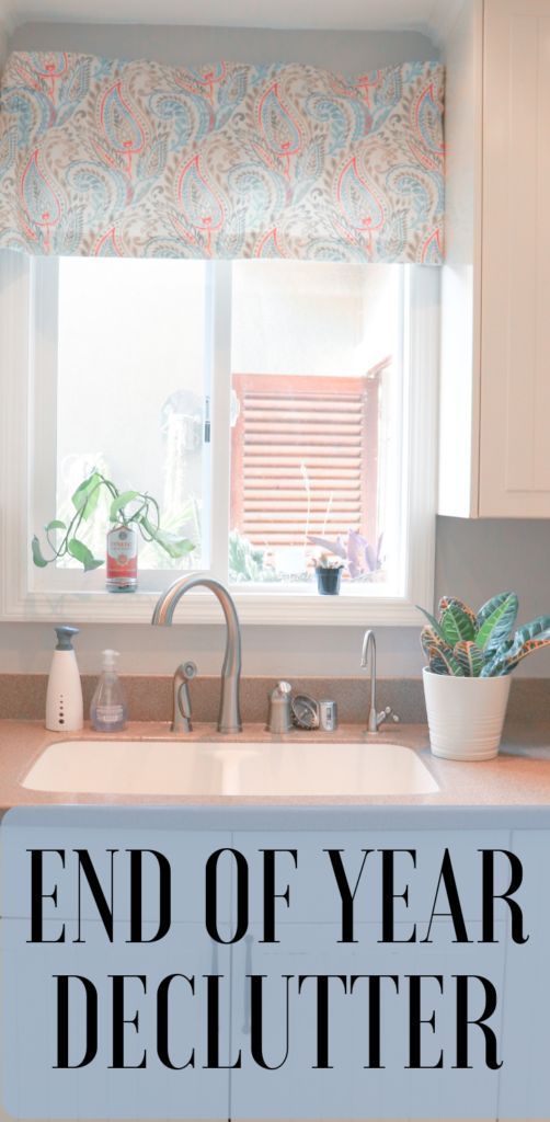 a kitchen sink under a window with the words end of year declutter on it