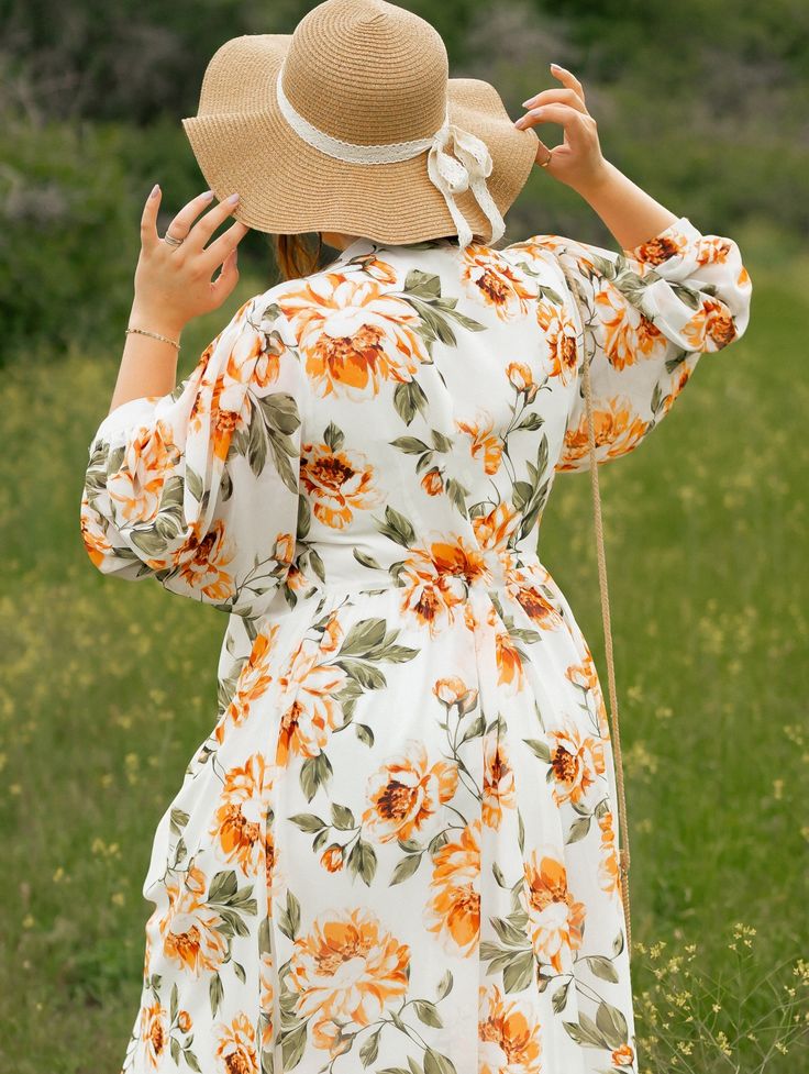 Get ready to run giddily through a field of flowers, because do we have the dress for you! This flowy midi-dress is not only comfortable but flattering. Note the high waist in the front which dips to a lower waist in the back to accentuate the natural curve of your back. The 3/4 sleeve bishop sleeves are flowy and fun, and the v-neck features an optional tie. If you're looking for maximum comfort and maximum cute, this dress is for you! All Poet dresses come with a cardstock poem delivered in a Spring Beach Maxi Dress With 3/4 Sleeves, Flowy Dresses With 3/4 Sleeves For Vacation, Flowy 3/4 Sleeve Maxi Dress For Summer, Summer Maxi Dress With 3/4 Sleeve For Daywear, Summer Maxi Dress With 3/4 Sleeves, Flowy Floral Midi Dress For Garden Party, 3/4 Sleeve Floral Midi Dress For Daywear, Knee-length Summer Floral Dress For Daywear, Floral Print Midi Dress With 3/4 Sleeves For Daywear