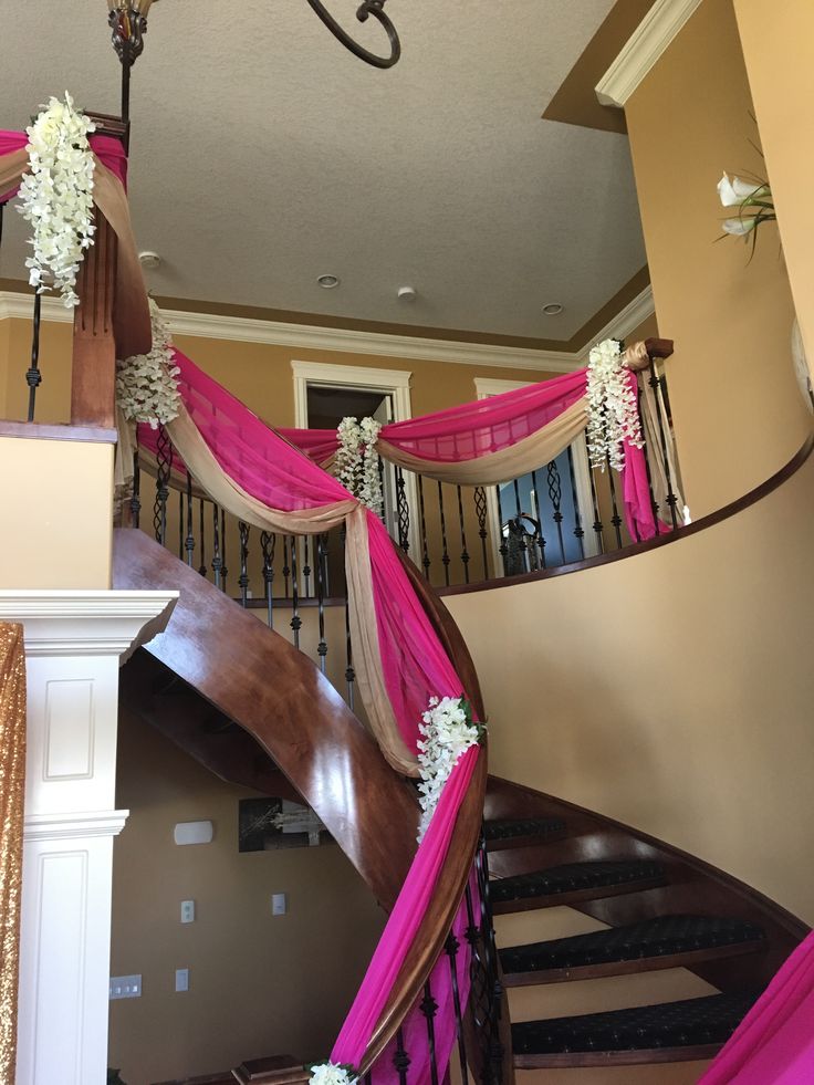 a staircase decorated with pink and white flowers