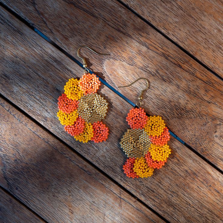 Pair of earrings hand-woven by me with Miyuki beads (Japanese glass beads) and a stainless steel frame. The gold colored beads are 24 karat gold beads. Artisan Gold Beaded Earrings, Traditional Gold Beaded Earrings With Colorful Beads, Gold Artisan Beaded Earrings With Dangling Beads, Gold Beaded Earrings With Colorful Beads, Handwoven Gold Drop Earrings, Gold Handwoven Drop Earrings, Traditional Gold Handwoven Beaded Earrings, Traditional Handwoven Gold Beaded Earrings, Handmade Gold Beaded Brass Earrings