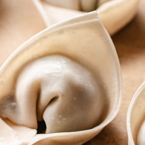 some dumplings are sitting on the table and ready to be eaten by someone else