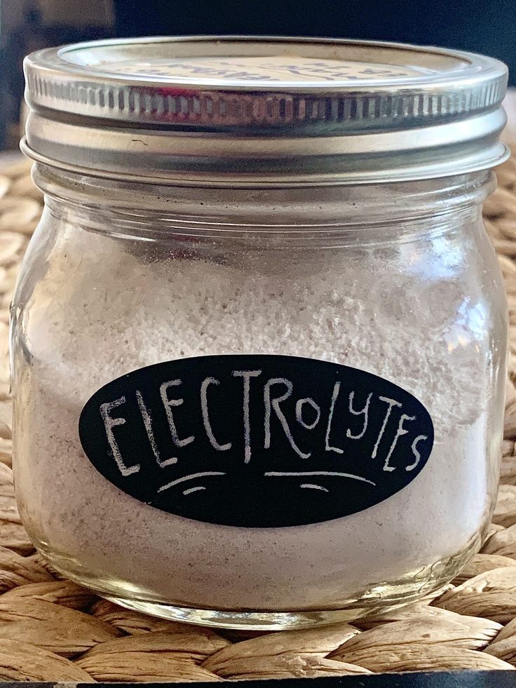 a glass jar filled with white powder on top of a table