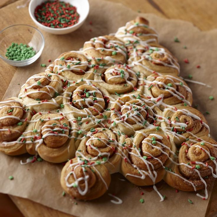 a bunch of doughnuts that are sitting on a wooden table with sprinkles