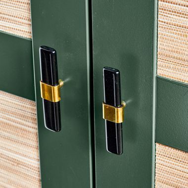 two black and gold handles on green doors