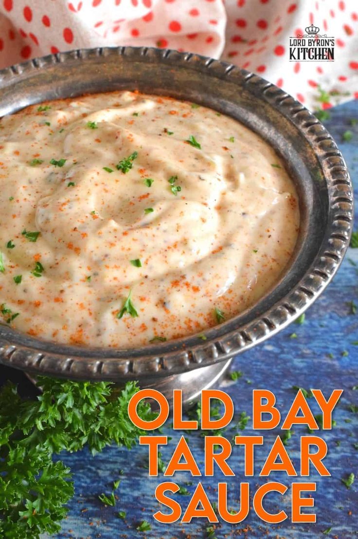 an old bay tartar sauce in a silver bowl with parsley on the side