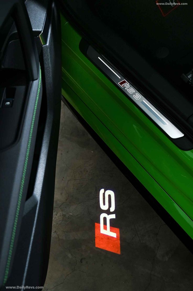 the logo on the side of a green car