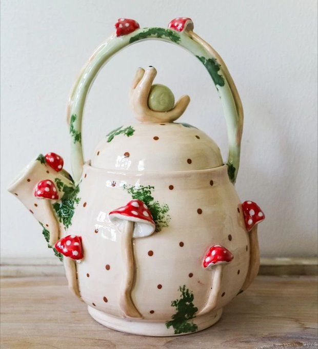 a ceramic tea pot with mushrooms on it