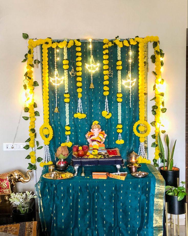 a decorated stage set up with lights and decorations for ganeshi pujamaal