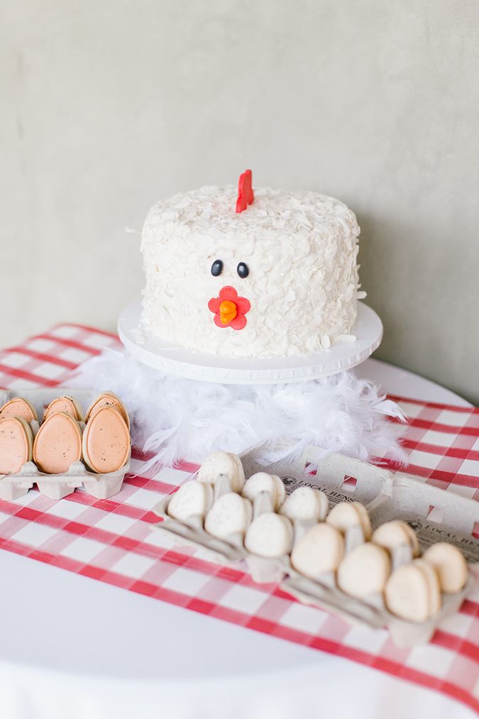 a white cake sitting on top of a table next to marshmallows