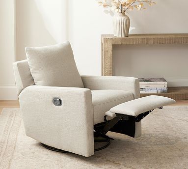 a white recliner chair sitting on top of a rug