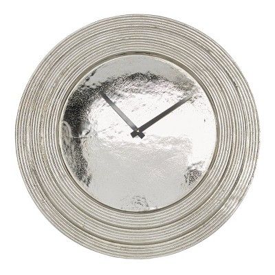 a round mirror with a clock in the middle on a white background, it appears to be made out of metal