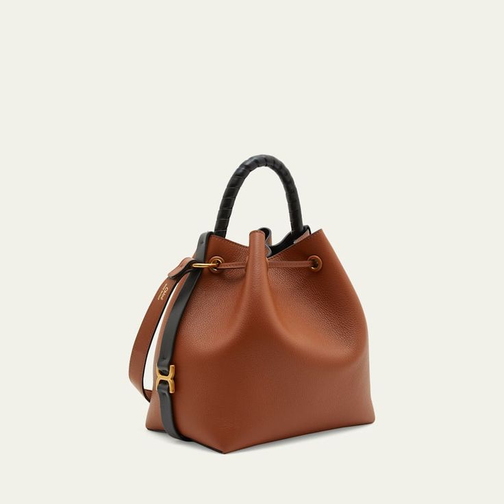 Chloe "Marcie" bucket bag in grained leather  Rolled top handle Detachable, adjustable crossbody strap, 19.6" drop Can be worn as a top handle or crossbody bag  Drawstring closure  Lining: Leather Approx. 6.7"H x 7.1"W x 3.9"D Item Weight (Lbs.): 1.1 Professional cleaning recommended Made in Italy Chloe Marcie, Professional Cleaning, 7 H, Crossbody Strap, Bucket Bag, Top Handle, Chloe, Crossbody Bag, Tops Designs