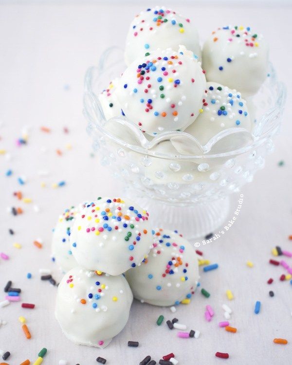 white chocolate truffles with sprinkles in a glass bowl on a table